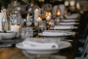 Mesa preparada con vajilla, cristalería y velas para una celebración